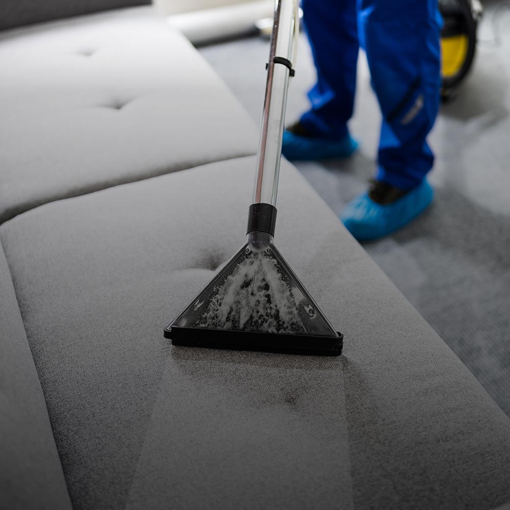 Technician Performing Couch Cleaning Service in Long Island